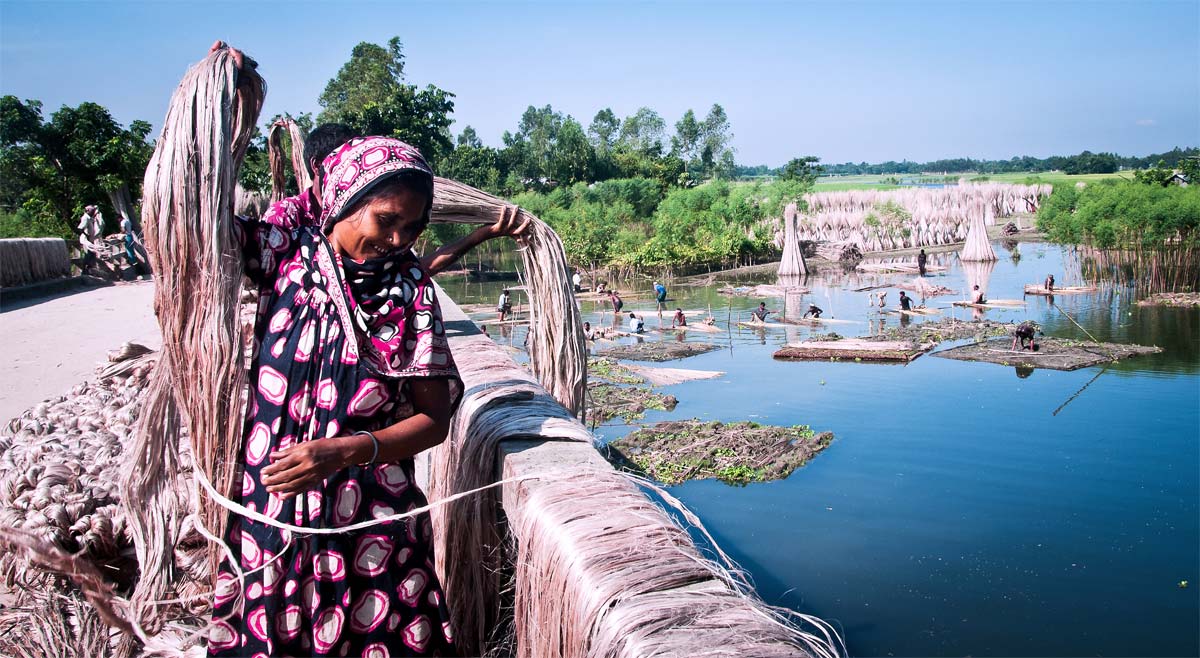 Woman at work, drying ropes on a railing.